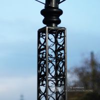 Close Up Of Intricate Scroll Work On Black Lamp Post Column Close Up Of Intricate Scroll Work On Black Lamp Post Column