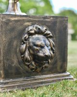 Close up of lion head detail on garden plinth