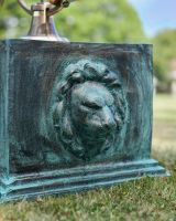Close up of lion head detail on garden plinth