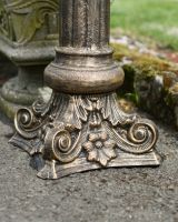 Close up of ornate base on garden plinth