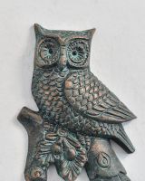 Close up of intricate owl detail on woodland verdigris coat hook Close up of intricate owl detail on woodland verdigris coat hook