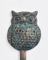Close up of owl detail on verdigris coat hook Close up of owl detail on verdigris coat hook