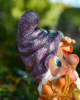 Close up of intricate detail on hat on colourful outdoor gnome statue