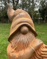 Close up of intricate detail on rustic finish garden gnome ornament Close up of intricate detail on rustic finish garden gnome ornament