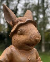 Close up of intricate detail on rustic finish bunny rabbit garden sculpture