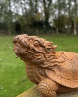 Close up of intricate dragon head detail on rustic finish garden sculpture Close up of intricate dragon head detail on rustic finish garden sculpture