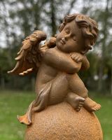 Close up of Rustic Cast Iron "Cassiel" the Sleeping Cherub Sculpture
