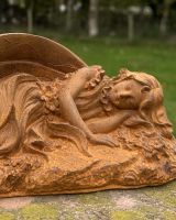 Close up of intricate detail on rustic cast iron fairy garden sculpture