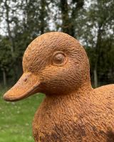 Close up of intricate detail on rustic cast iron duck garden sculpture