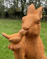 Close up of intricate bird detailing on woodland garden statue