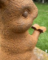 Close up of intricate detail on rustic reading rabbit outdoor statue