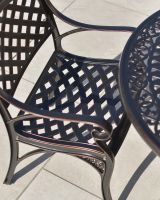 detailed close up of aluminium chair lattice detail on antique copper chair set detailed close up of aluminium chair lattice detail on antique copper chair set