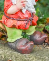 Close up of intricate shoe detail on colourful garden gnome statue