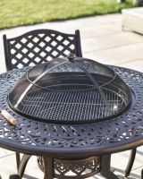 close up of round table detail with bbq centre close up of round table detail with bbq centre