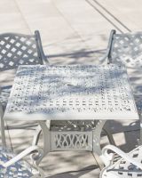 close up on table top and chair detail on blanche garden set white