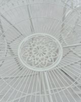 Close up of ornate table top detail on four seater patio dining set Close up of ornate table top detail on four seater patio dining set