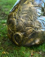 Close up of curly tail detail on farmyard patio ornament