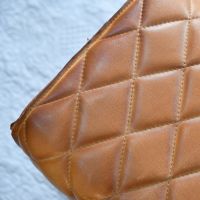 Close up of intricate diamond stitching on leather foot stool