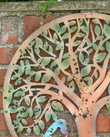 Close up of rustic natural tree detailing on garden wall art