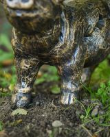 Close up of intricate trotter detail on brushed gold pig garden statue
