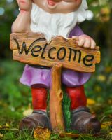 Close up of welcome sign on "Cyril" the Welcoming Garden Gnome Close up of welcome sign on "Cyril" the Welcoming Garden Gnome