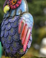 Close up of wing detail on colourful patio ornament