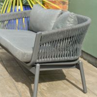 Close up of charcoal grey woven rope detail on five person patio lounge furniture set Close up of charcoal grey woven rope detail on five person patio lounge furniture set