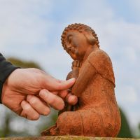 Side view of Resting Buddha Rustic Cast Iron Sculpture 