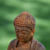 High Angle Shot of Rustic Cast Iron Sitting Buddha Sculpture