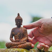 Close up of Meditating Buddha with Hand for Scale 