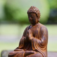 Close up of Praying Buddha Sculpture 