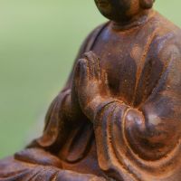 Close up of Praying Hands on Buddha Sculpture 