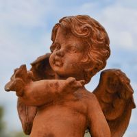 Close up of Rustic Cast Iron Cherub Sculpture 