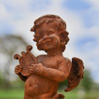 Close up of Cherub"s face on Cast Iron Sculpture 