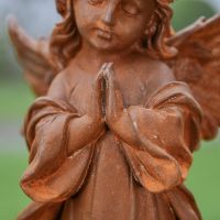 Close up of Praying Hands on Rustic Cast Iron Garden Sculpture 