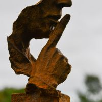 Close up of Hand on Silencer Sculpture 