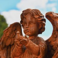 Close-Up of Rustic Cast Iron Winged Angel & Dove Sculpture