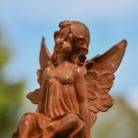 Close-Up of Rustic Cast Iron Sitting Fairy Sculpture