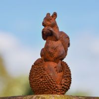 Rustic Cast Iron Squirrel & Chestnut Sculpture in Garden
