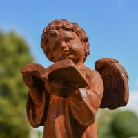 Close up of Angel Reading Garden Sculpture 