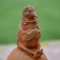 Close-Up of Rustic Cast Iron Sitting Pigeon Sculpture