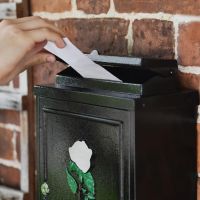 Letter being deposited through letter flap 