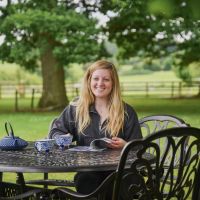 Female Seated at Moreville Furniture Set 