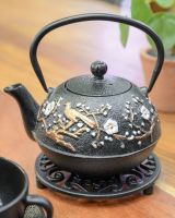 "Hasu" Cast Iron Japanese Style Trivet in Black with a Cast Iron Teapot on top