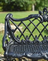 Close up of lattice detail on black garden bench