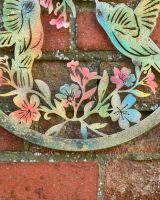 Close up of ornate detailing on garden wall art