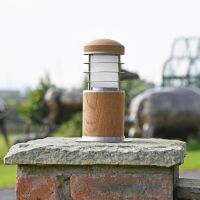 Compact Wooden Bollard Light on a Brick Pillar in the Garden Compact Wooden Bollard Light on a Brick Pillar in the Garden