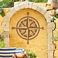 Compass Wall Art in Situ on a Yellow Garden Wall Compass Wall Art in Situ on a Yellow Garden Wall