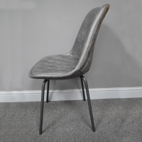 View of the Side of the Grey Leather Dining Chair