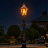 Copper Hexagonal Miniature Lamp Post Illuminated at Night